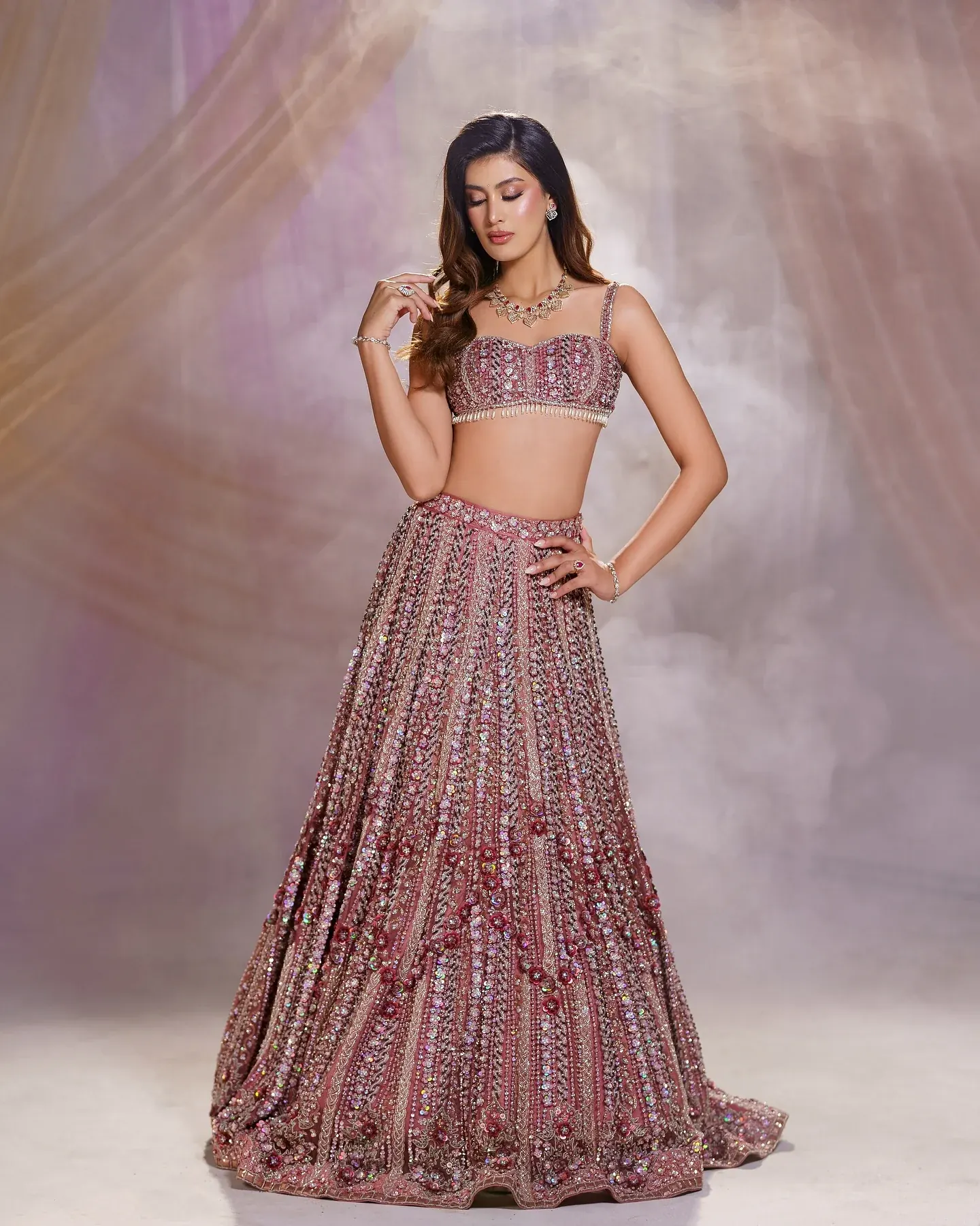 A mauve lehenga with striped bead work, photographed against a soft ground.