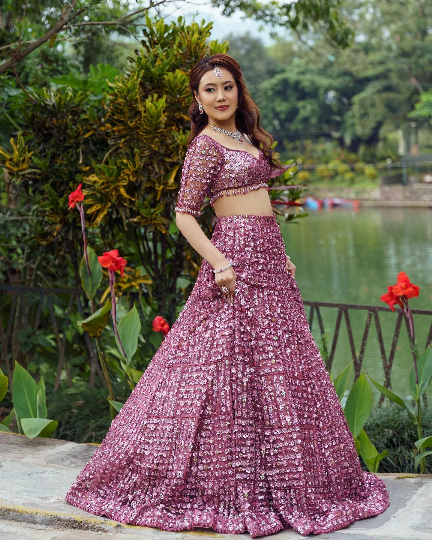 A mauve lehenga with sequinned panels and a beaded blouse, photographed in a garden.